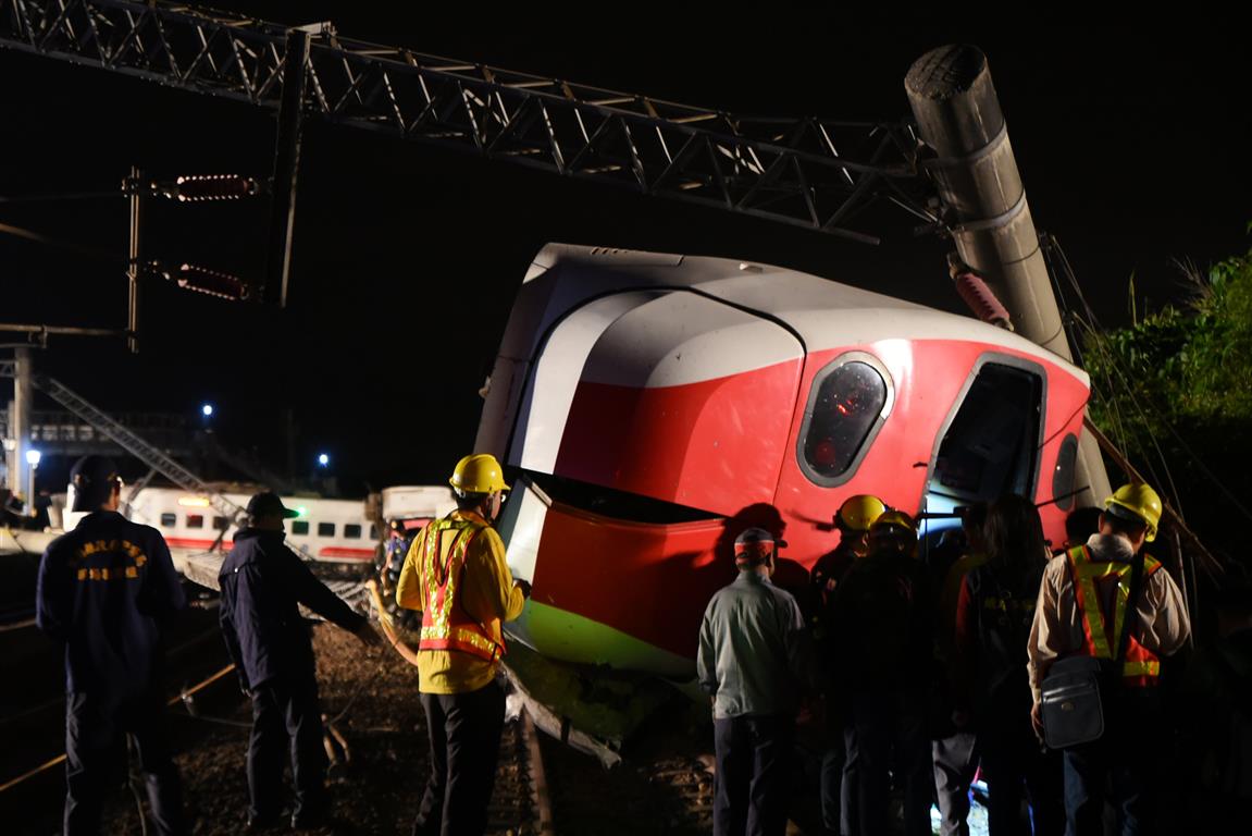 Rescue workers at the scene after the train dereailed. Photo: Reuters
