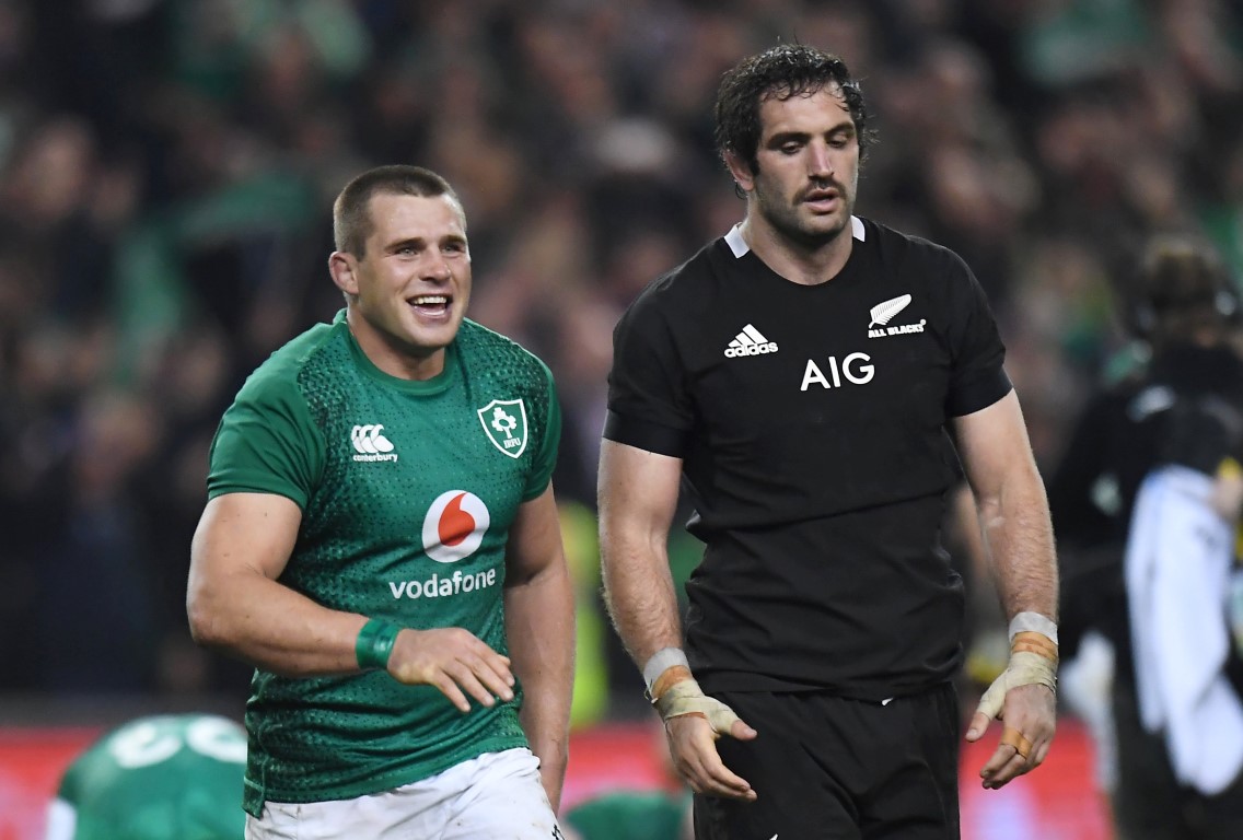 Displaying mixed emotions after the match are Ireland's CJ Stander (L) and New Zealand's Sam...