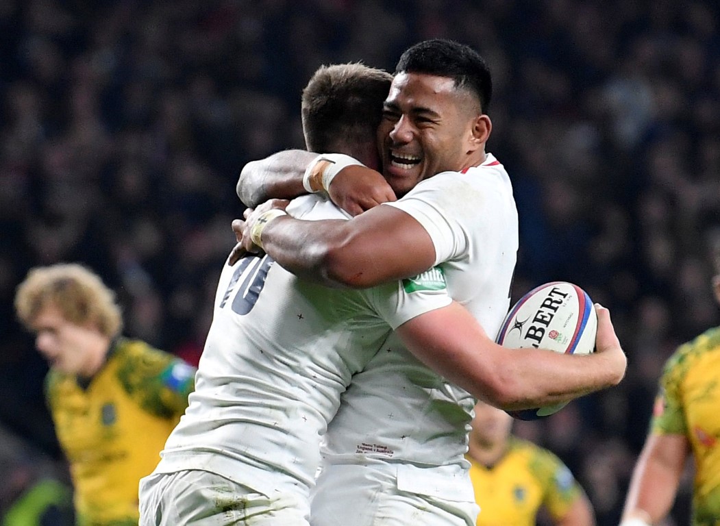 England's Owen Farrell (L) celebrates with Manu Tuilagi after scoring their fourth try. Photo:...