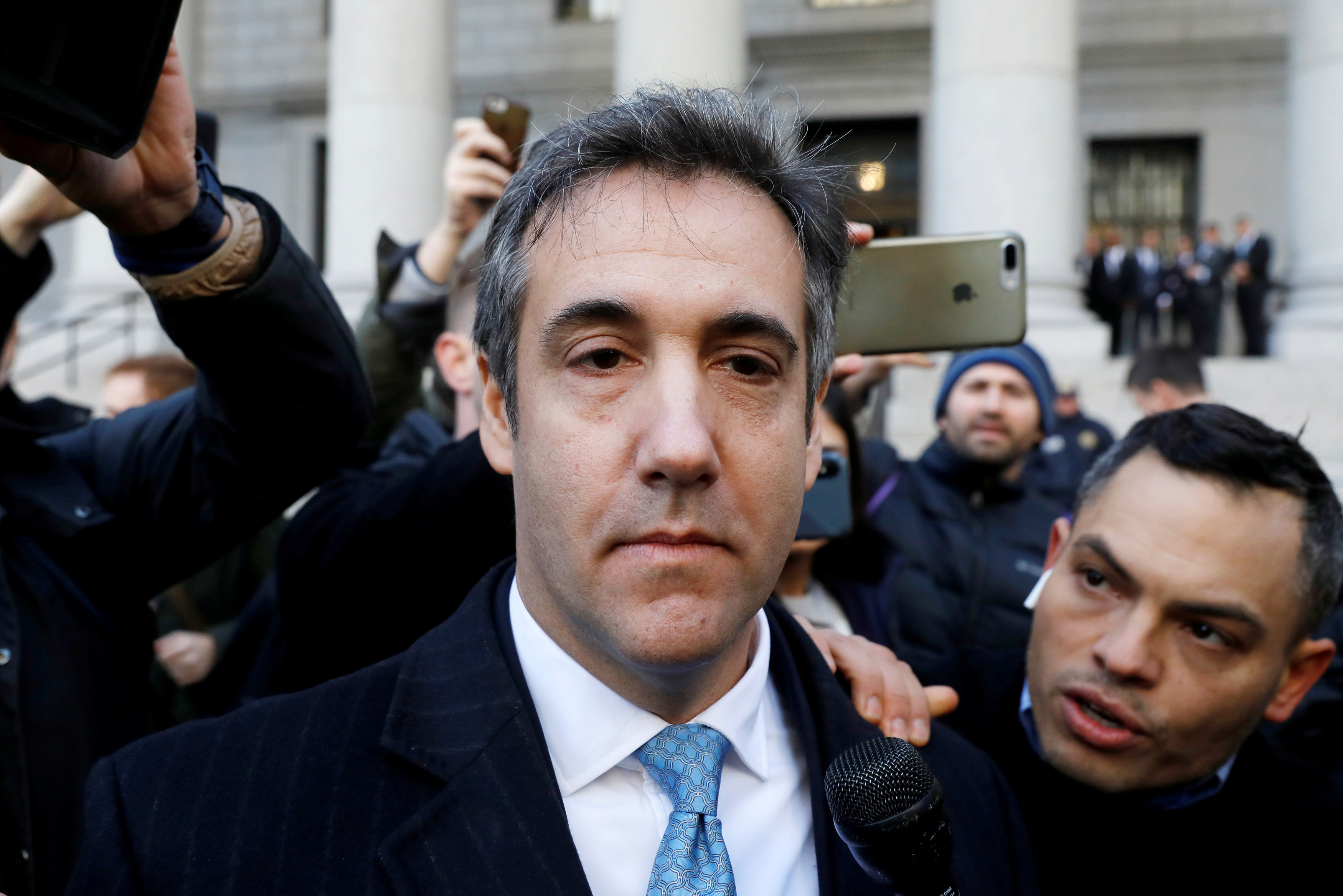 Michael Cohen exits Federal Court after entering a guilty plea in Manhattan. Photo Reuters