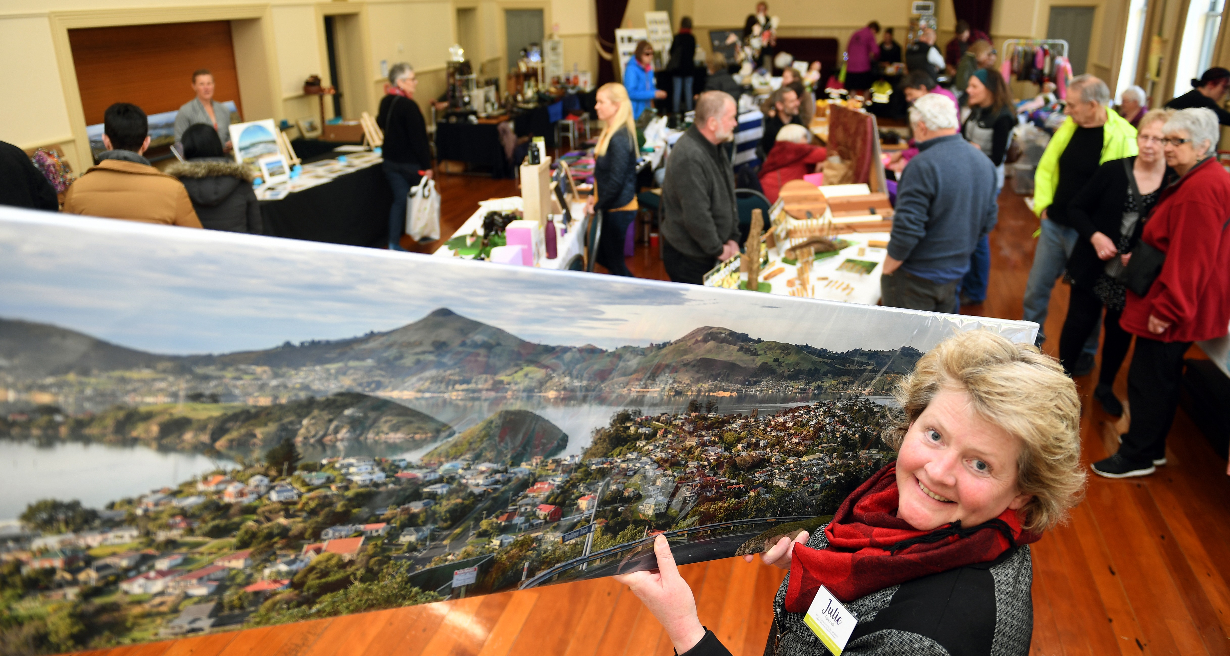 Author Julie Fawcett holds a large Andy Thompson panoramic photo of Port Chalmers yesterday....