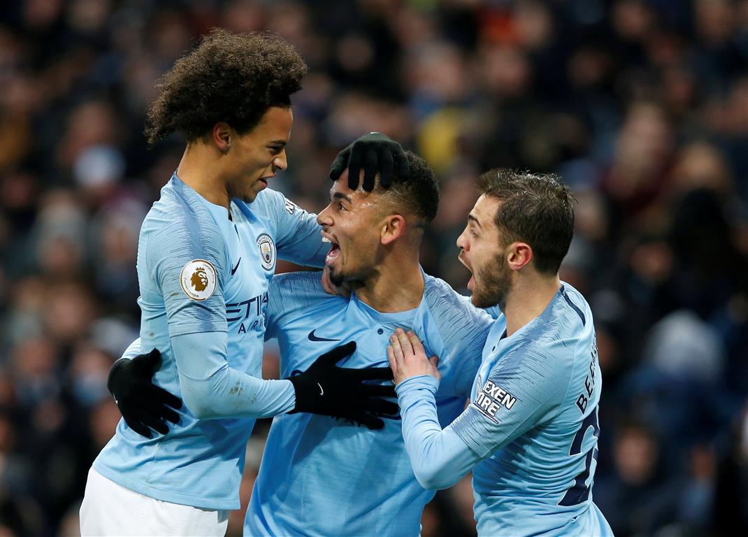 Manchester City's Gabriel Jesus (C) celebrates with Leroy Sane (L) and Bernardo Silva after...