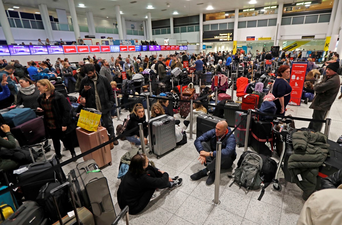 Passengers wait in the South Terminal building at Gatwick Airport after drones flying over the...