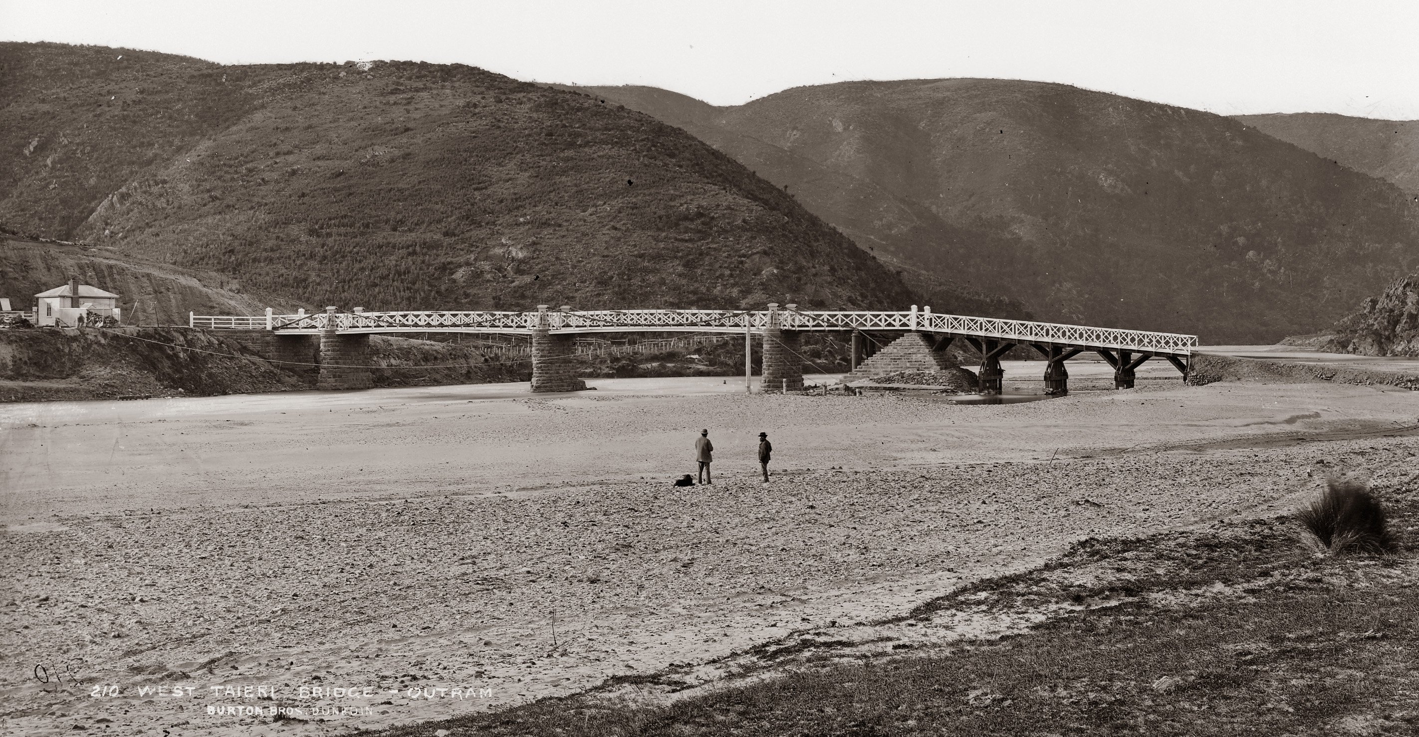 "The river was low, just covering the shingle beds, and looked dirty compared with the...