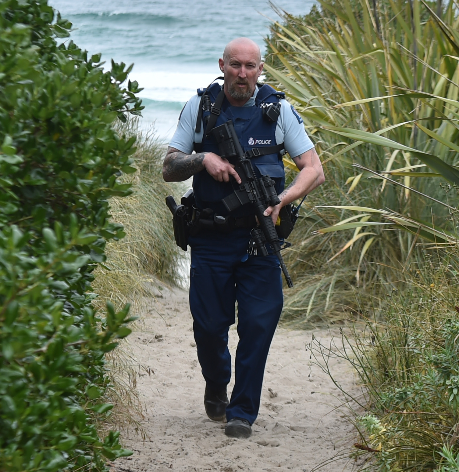 Armed police searched the beach and dunes at Ocean View on Friday evening for an offender. Photo:...