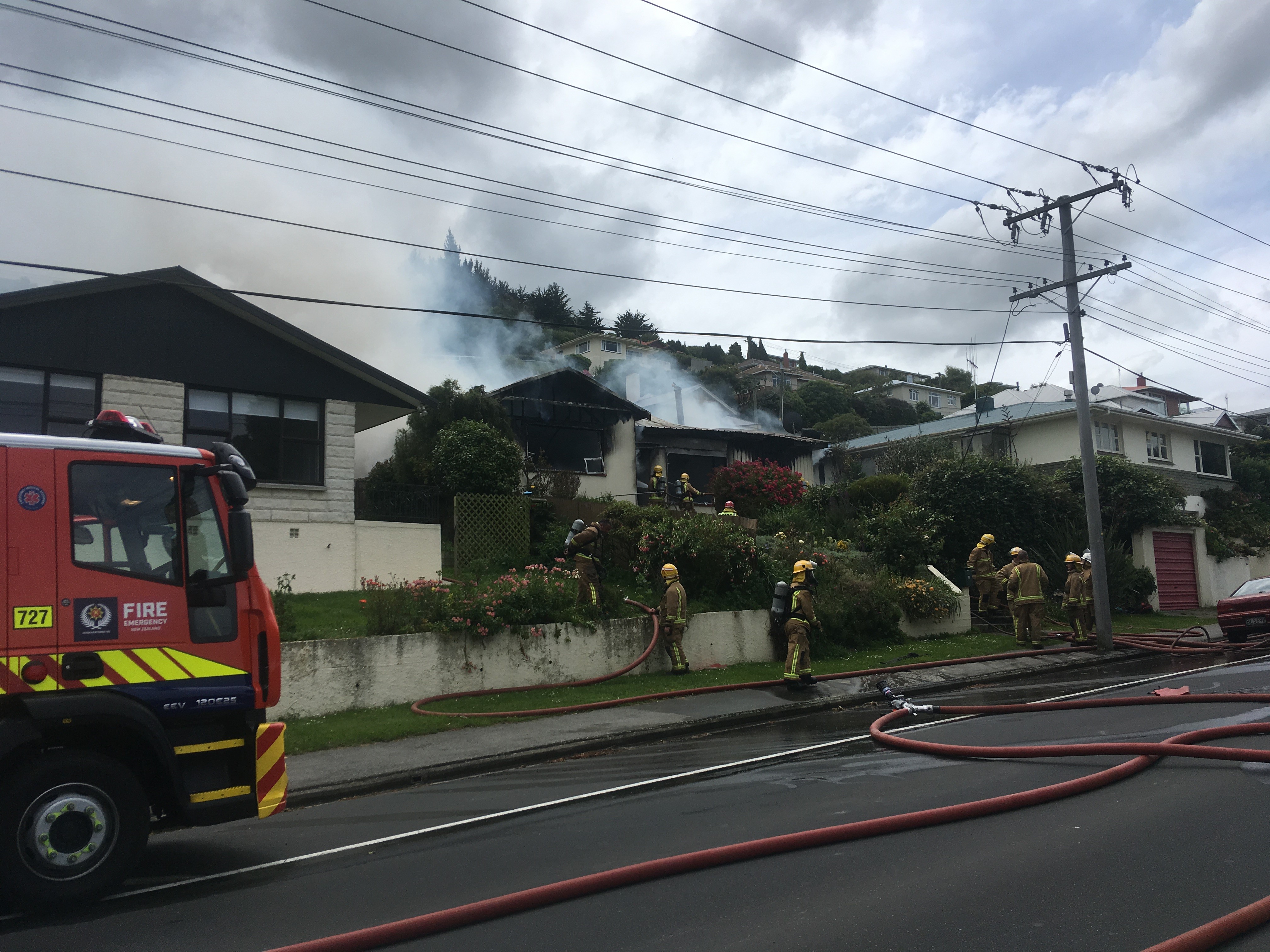 Firefighters battle a blaze in Oamaru this afternoon. Photo: Hamish MacLean
