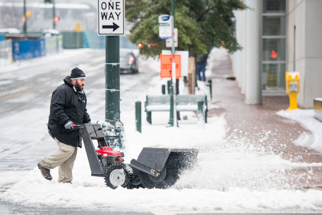 A man operates a snow sweeper in Charlotte, North Carolina. Photo: Getty