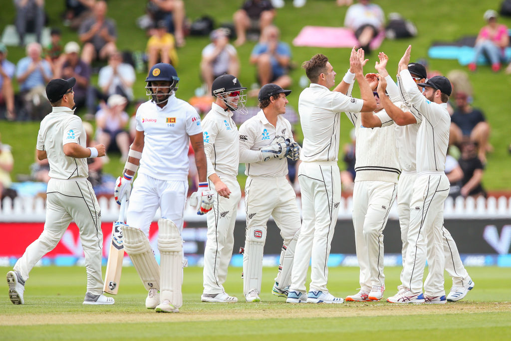 New Zealand's Tim Southee (4th R) celebrates with teammates after taking the wicket of Sri Lanka...