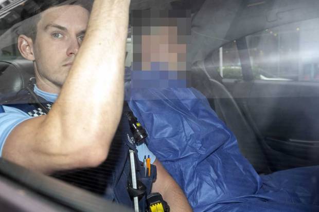 The man accused of murdering Grace Millane is driven to the Auckland District Court accompanied by a police officer, left. Photo: NZME