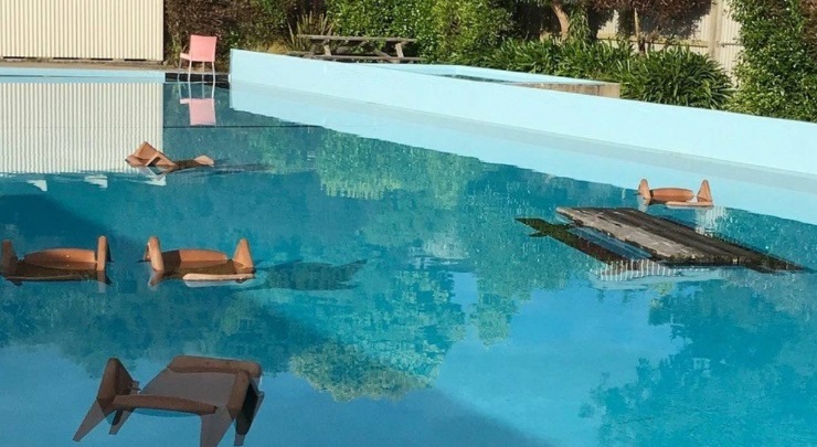 The pool had only been open three days after a $28,000 spruce-up, when someone climbed over the fence and threw the poolside furniture into it.  Photo: Supplied