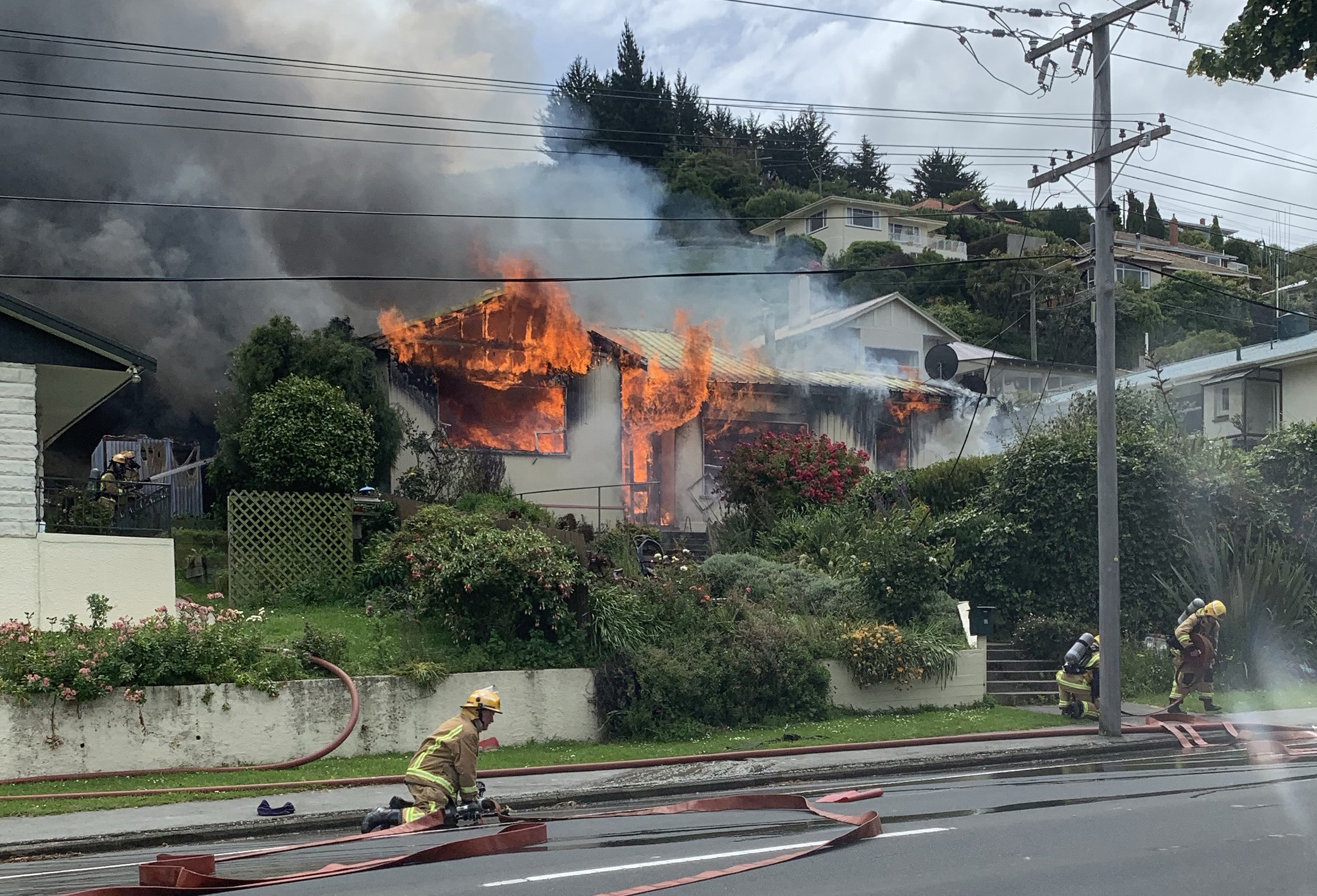 Fire crews work to put out a fire that destroyed a Reed St, Oamaru, home and set alight a...