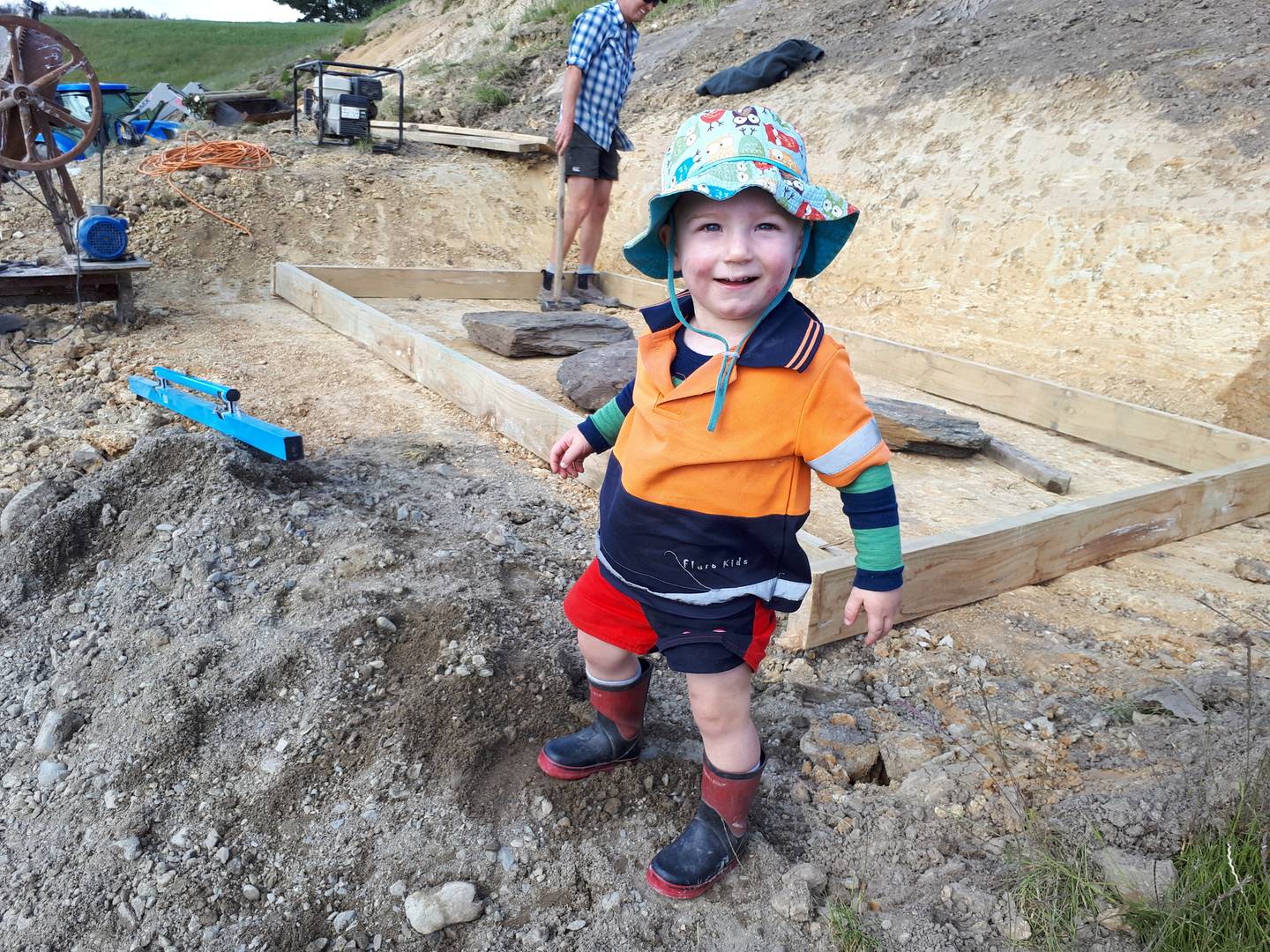 Sam Tomlinson as his dad and friends work on a memorial to his mum and brother. Photo: NZ Herald