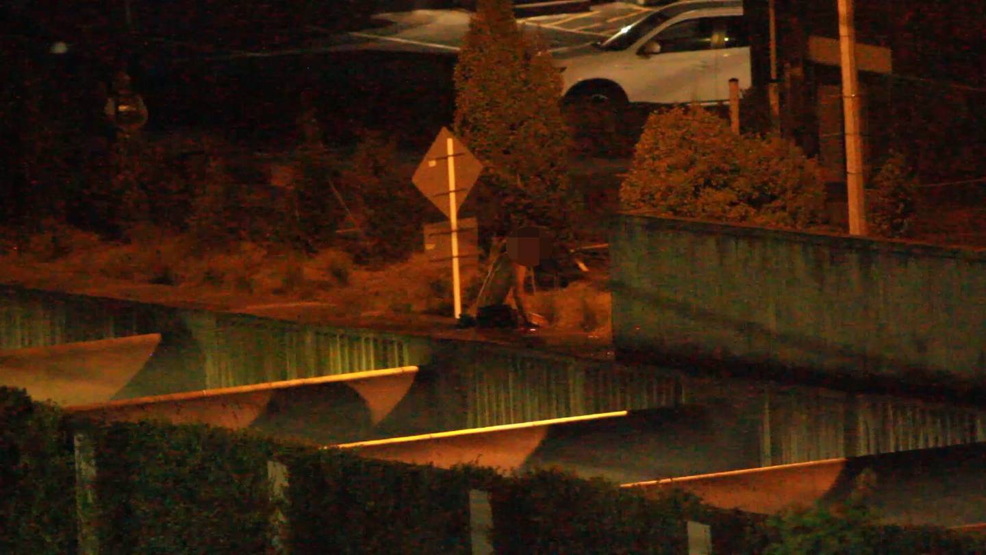 The man about to step down from the pipes near the end of the incident. Photo: NZ Herald