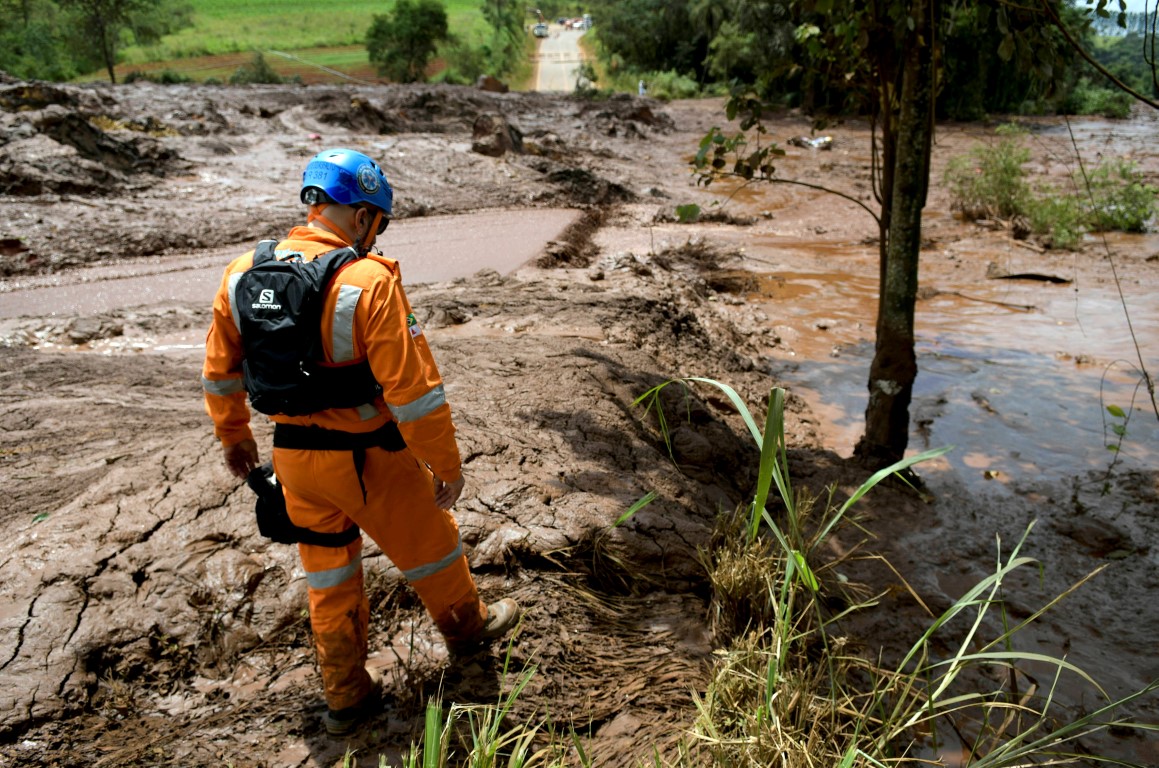 A rescue worker surveys the scene after the dam burst. Photo: Reuters