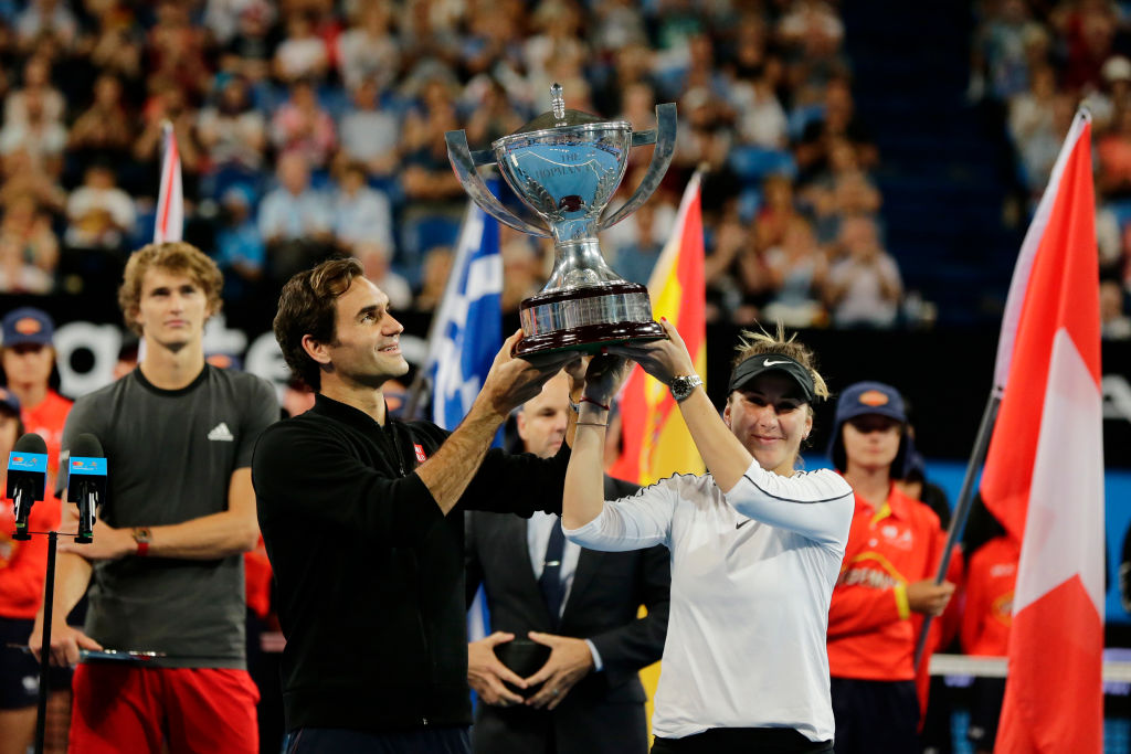 Switzerland's Roger Federer and Belinda Bencic raise the Hopman Cup after defeating Germany's...