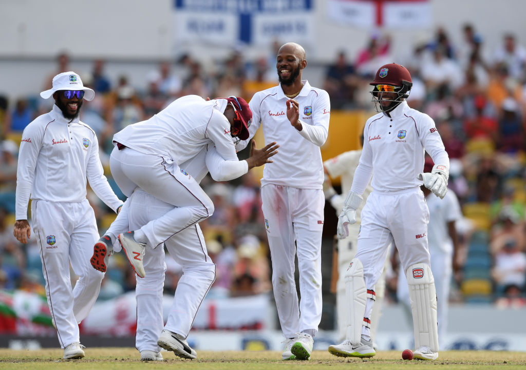 Roston Chase (2nd R) celebrates a wicket with teammates. Photo: Getty