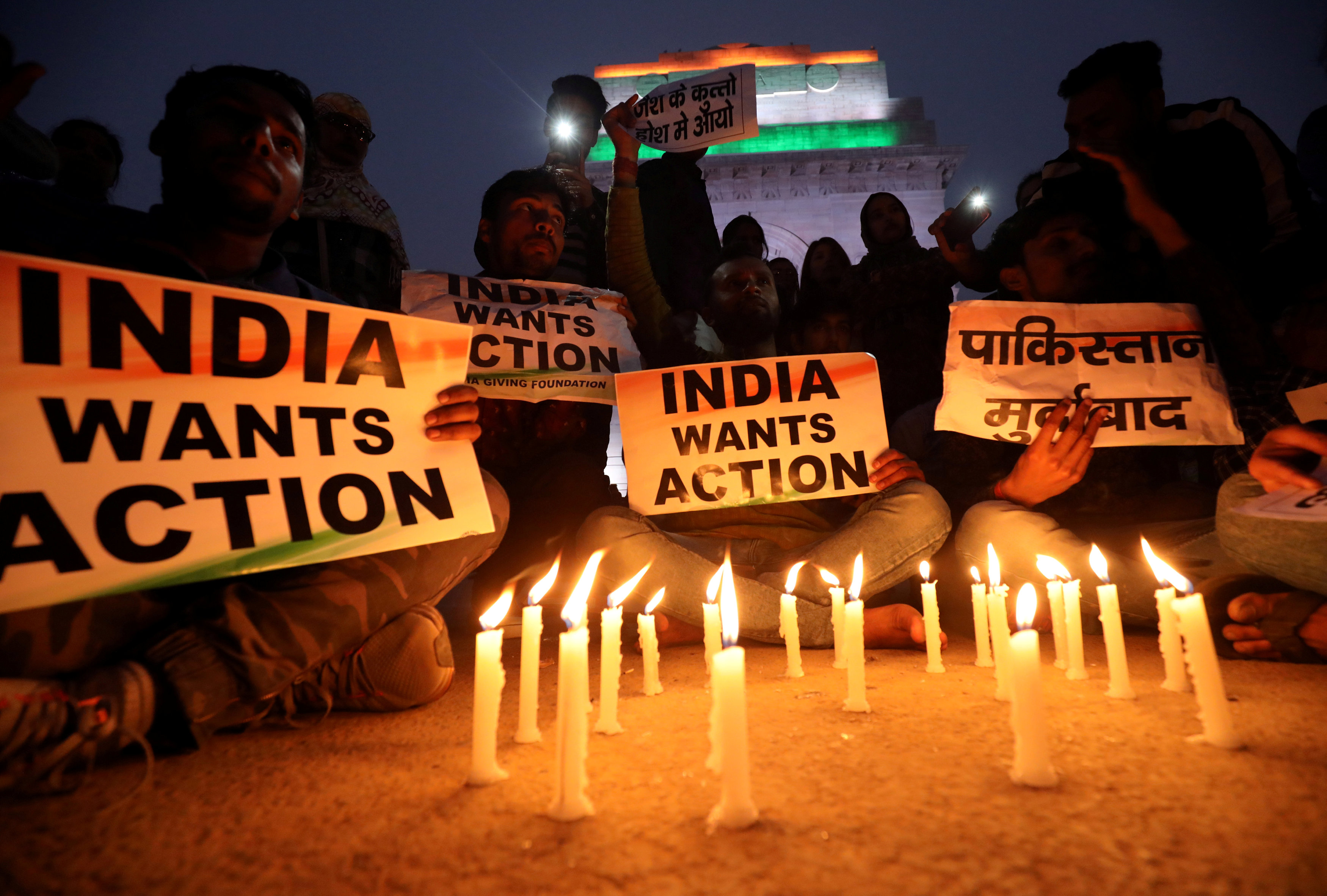 People attend a candle-light vigil to pay tribute to victims of the suicide bomb attack. Photo:...