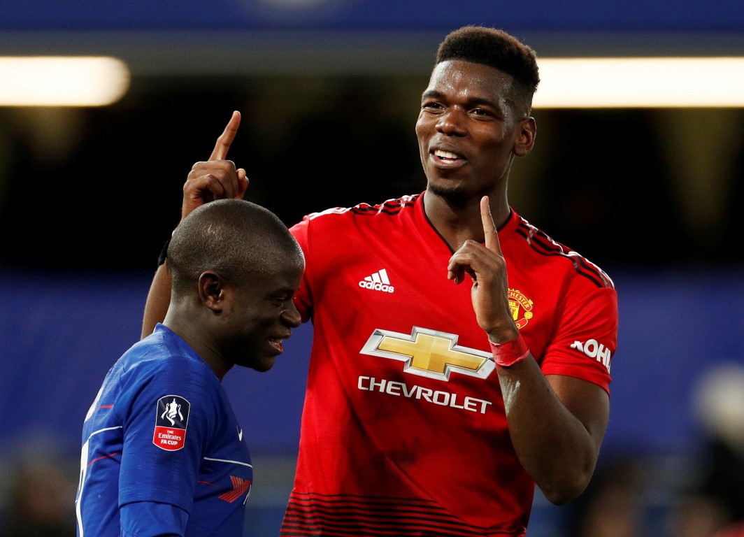 Manchester United's Paul Pogba (R) gestures alongside Chelsea's N'Golo Kante at the end of the...