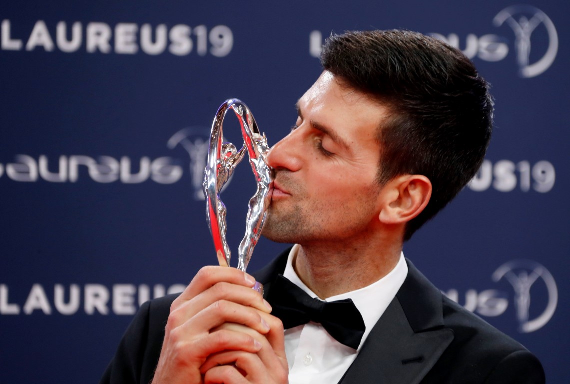 Novak Djokovic kisses the trophy after being named sportsman of the year. Photo: Reuters