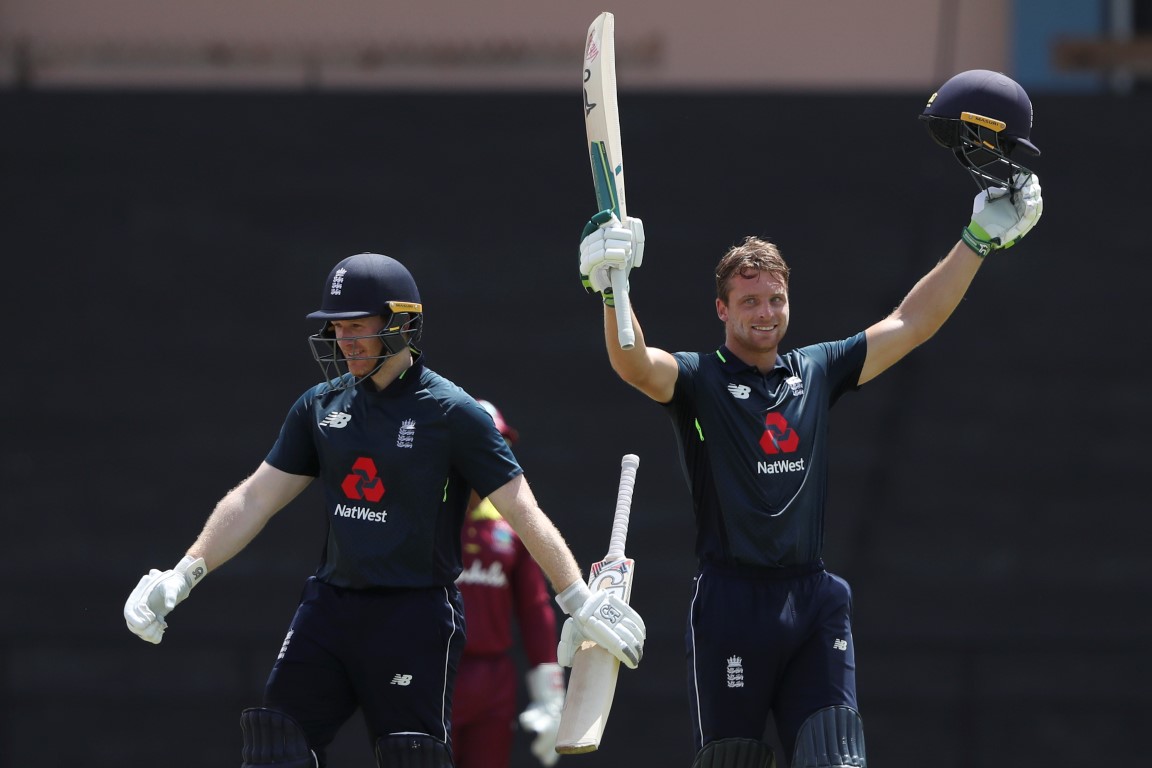 England's Jos Buttler (R) celebrates with captain Eoin Morgan after reaching his century against...