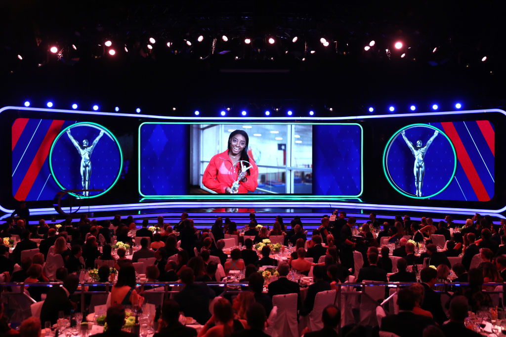 Simone Biles accepts her award via video screen. Photo: Getty