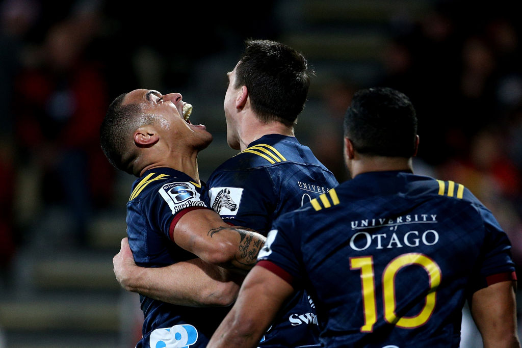 Highlanders fullback Ben Smith (C) celebrates with team-mate Aaron Smith after scoring a try...