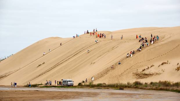 The sand dunes at Te Paki are a popular attraction for tourists who are encouraged to ride boards...