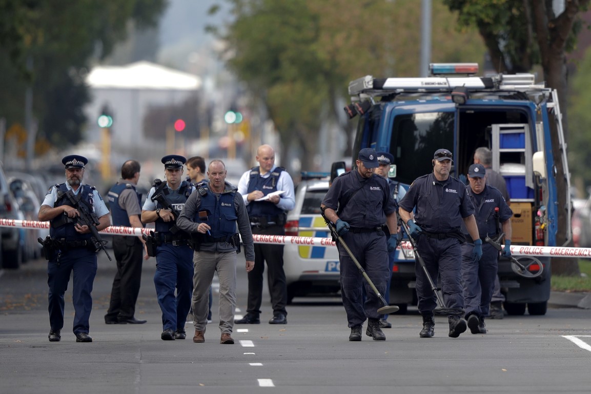 Police officers search the area near the Masjid Al Noor mosque in Christchurch following the...