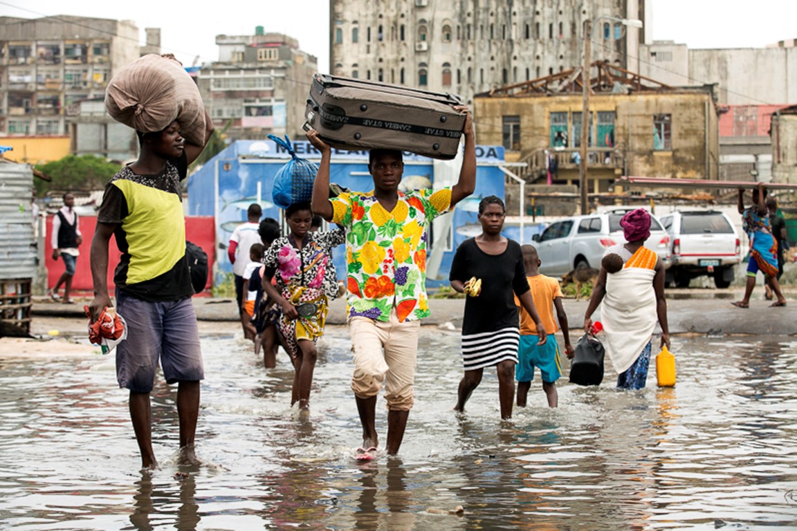 People carry their personal effects after Tropical Cyclone Idai hit, in Beira, Mozambique. Photo: AP