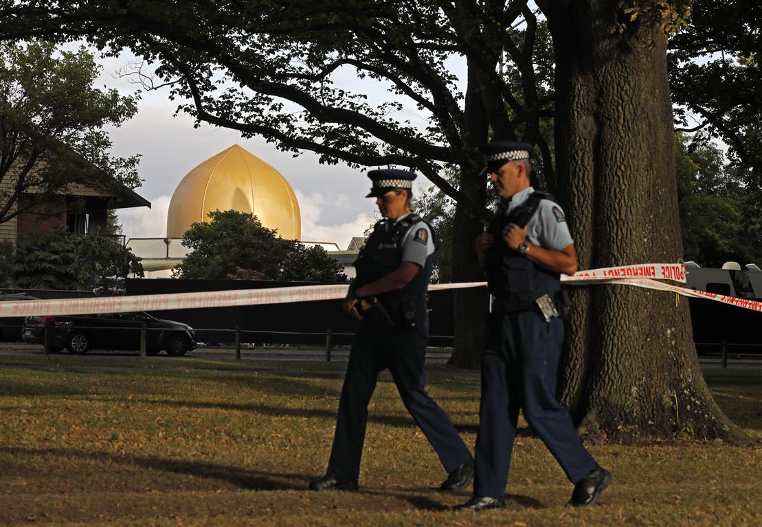 Police officers patrol at a park outside the Al Noor mosque in Christchurch this week. Photo: AP