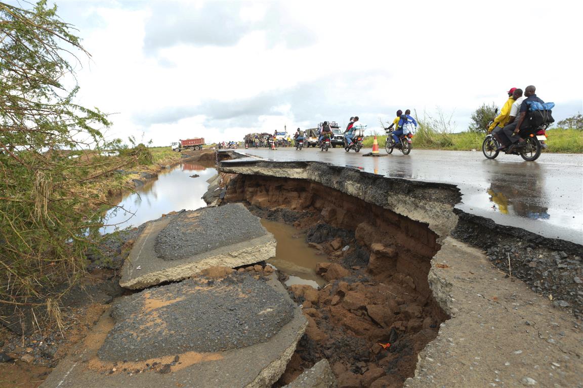 Motorcycles pass through a section of road damaged by Cyclone Idai in Nyamatanda, about 50km from...