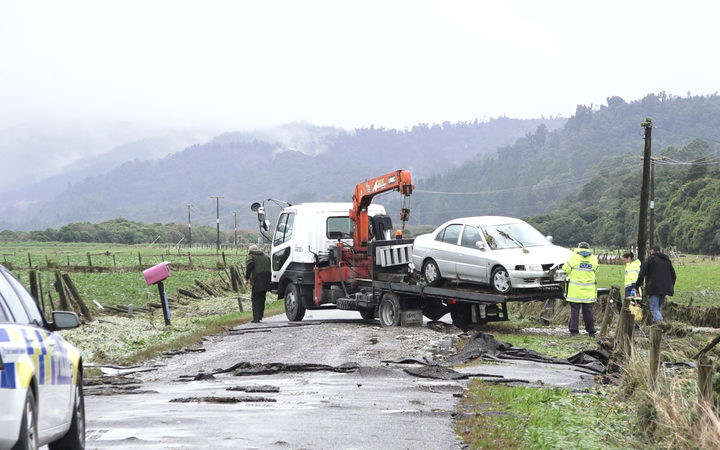 The car of a woman who died in flood waters north of Hokitika is removed. Photo: RNZ The car of a woman who died in flood waters north of Hokitika is removed. Photo: RNZ