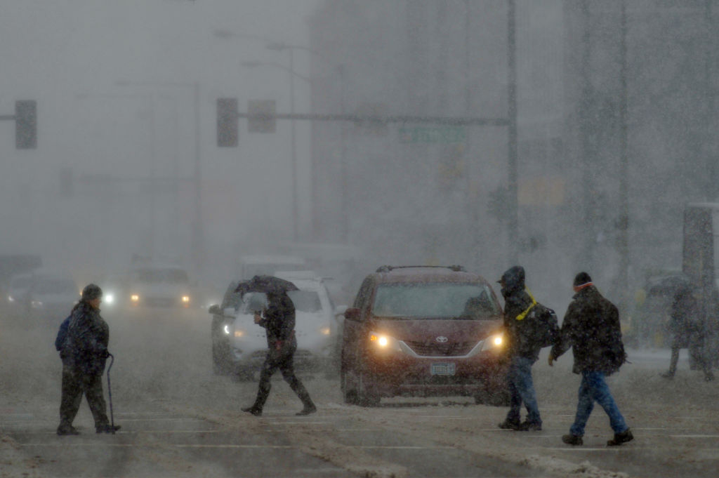 Pedestrians brave the weather in downtown Denver, Colorado. Photo: Getty Images