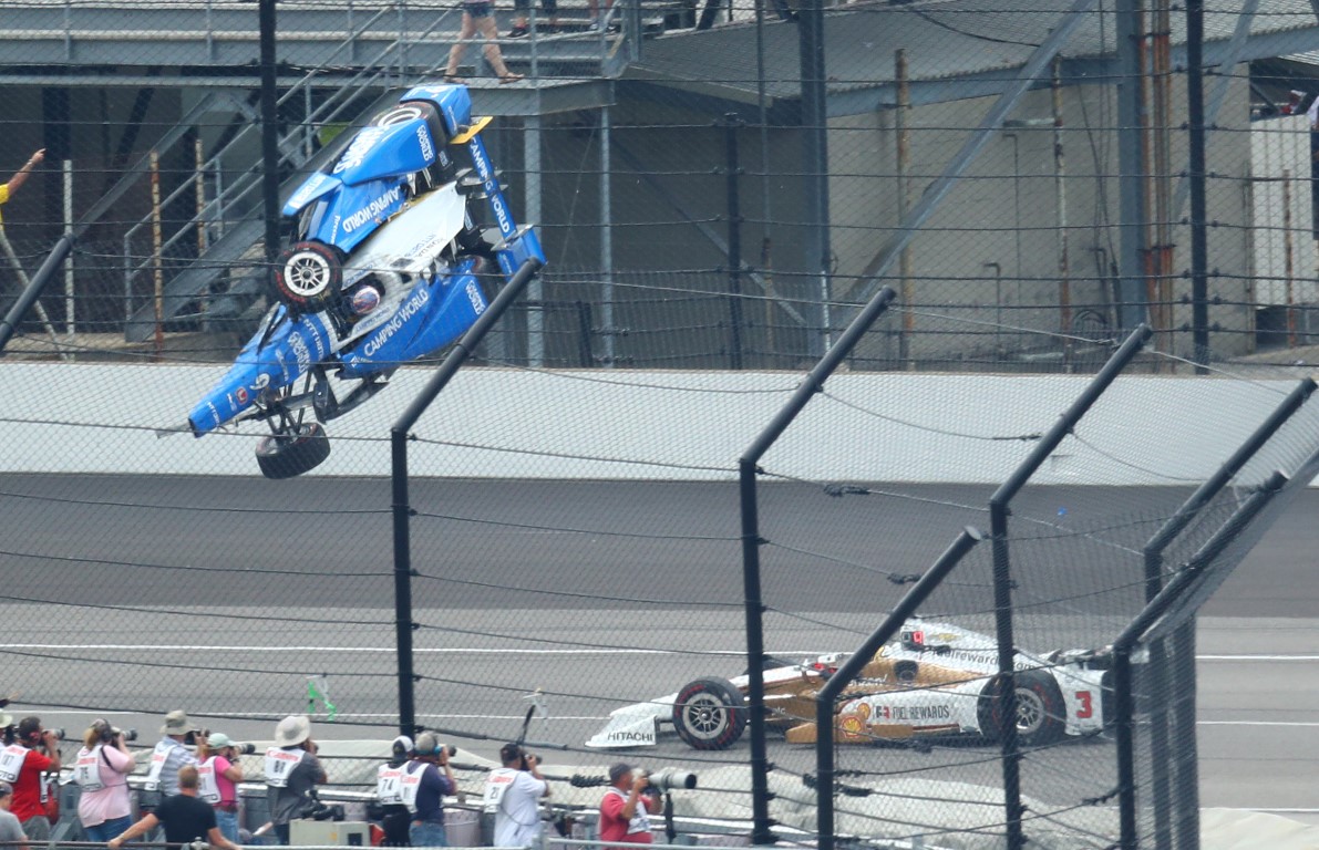 Scott Dixon goes airborne and crashes in front of Helio Castroneves during the race at...