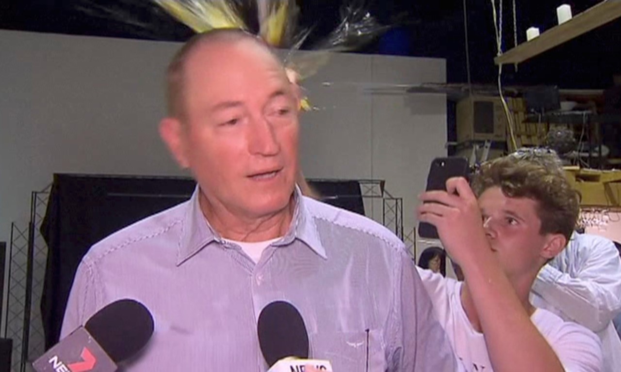 Will Connolly breaks an egg on the head of Senator Fraser Anning during a press conference in...