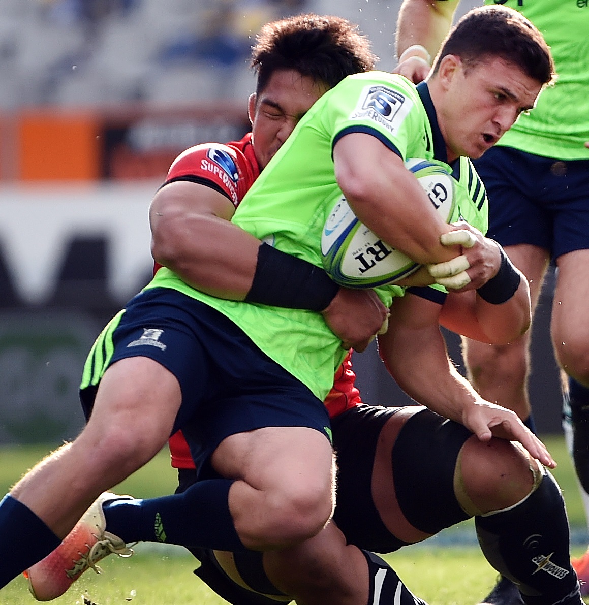 Bravehearts first five-eighth Bryn Gatland is tackled by Wolf Pack flanker Kazuki Himene at...