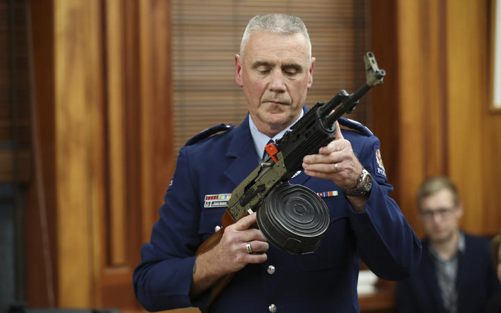 Police officer Paddy Hennan demonstrates illegal gun modifications at the select committee...