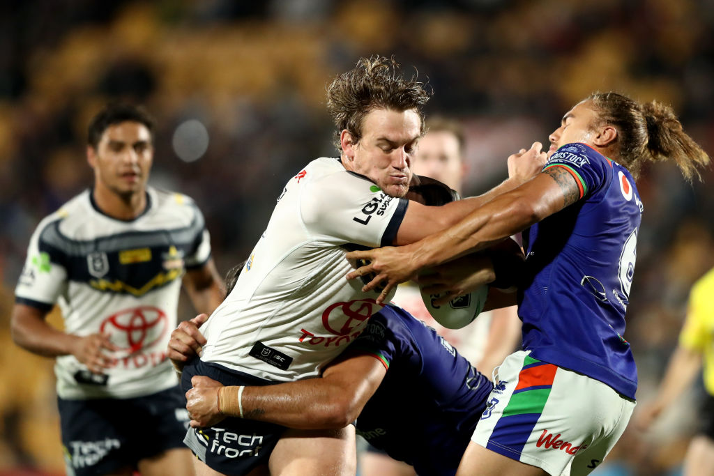 The Cowboys' Coen Hess fends off the Warriors' Chanel Harris-Tavita. Photo: Getty 