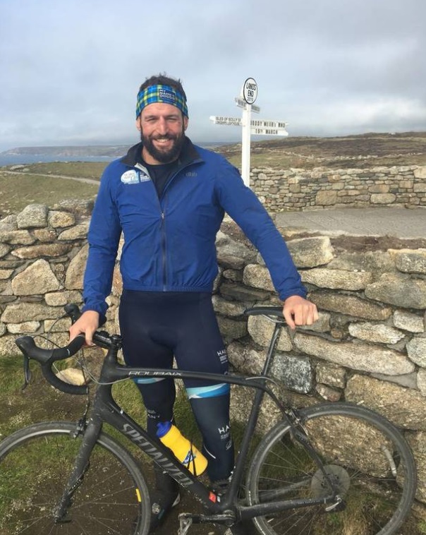 Carl Hayman at Land's End in England after completing a cycle ride for charity in 2019. Photo via...