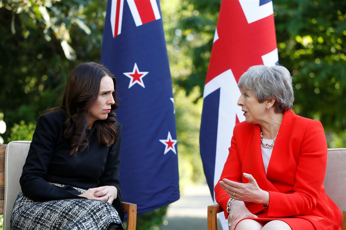 British Prime Minister Theresa May (R) and New Zealand Prime Minister Jacinda Ardern talk at the...