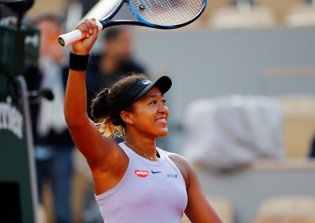 Naomi Osaka acknowledges the crowd after winning her first round match against Slovakia's Anna...