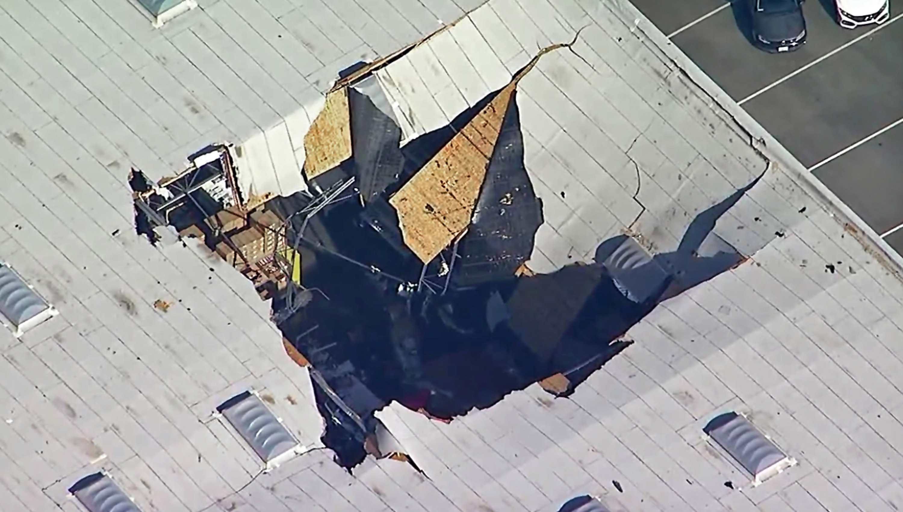 The hole left by the fighter jet after it crashed into the warehouse. Photo: AP