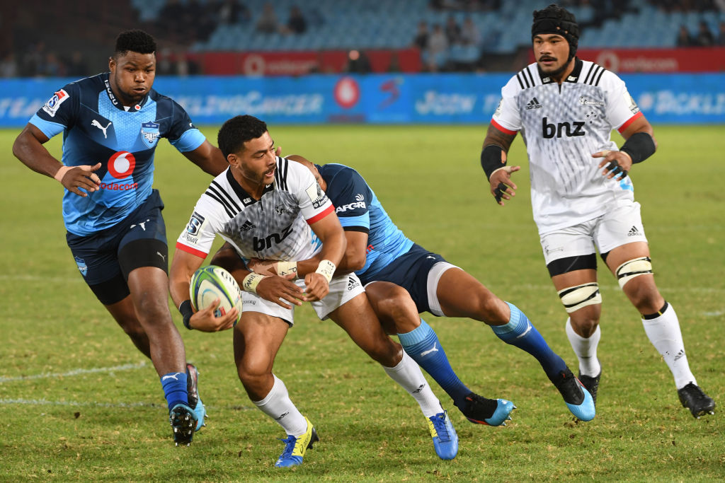 Richie Mo'unga looks to offload in the tackle of a Bulls defender. Photo: Getty