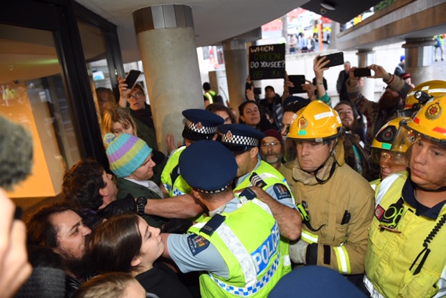 Police try to force their way past protesters at the town hall this morning. Photo: Stephen Jaquiery