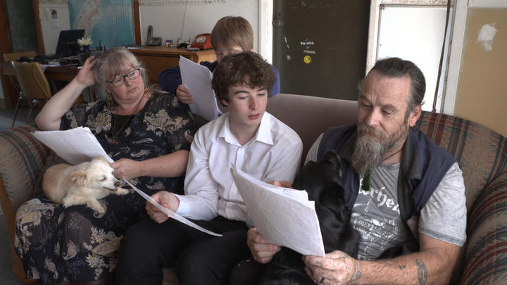 The Lambert family - Stephanie Logan, Cairo and Chris - look through documents about their...