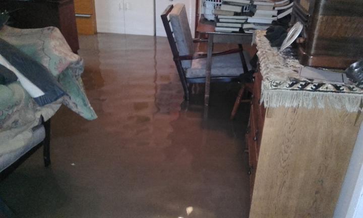 Floodwaters in the Lamberts' house have forced them to stack furniture and valuables to keep them...