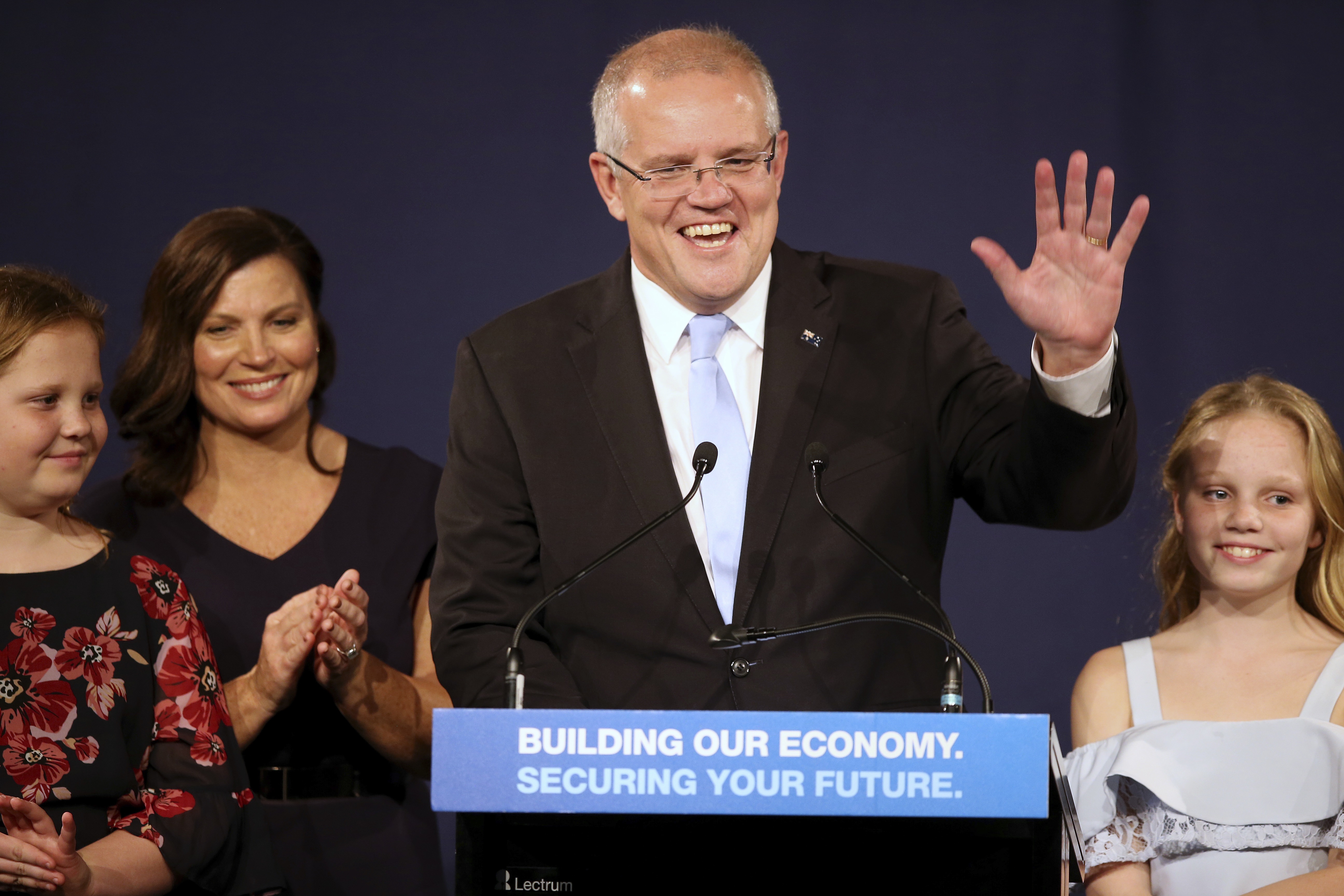 A victorious Scott Morrison thanks party supporters accompanied by wife Jenny and daughters Abbey...