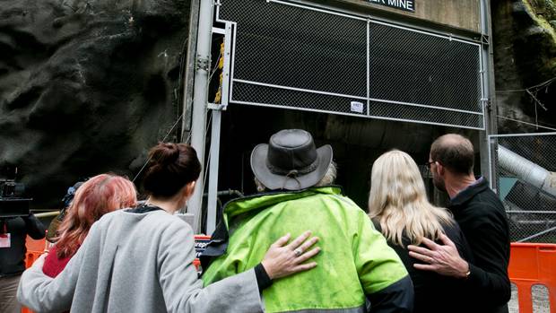 Prime Minister Jacinda Ardern and Andrew Little join grieving families as they gather outside the...