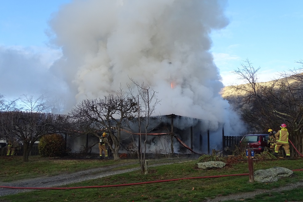 Firefighters work to control the blaze in Wanaka this morning. Photos: Kerrie Waterworth