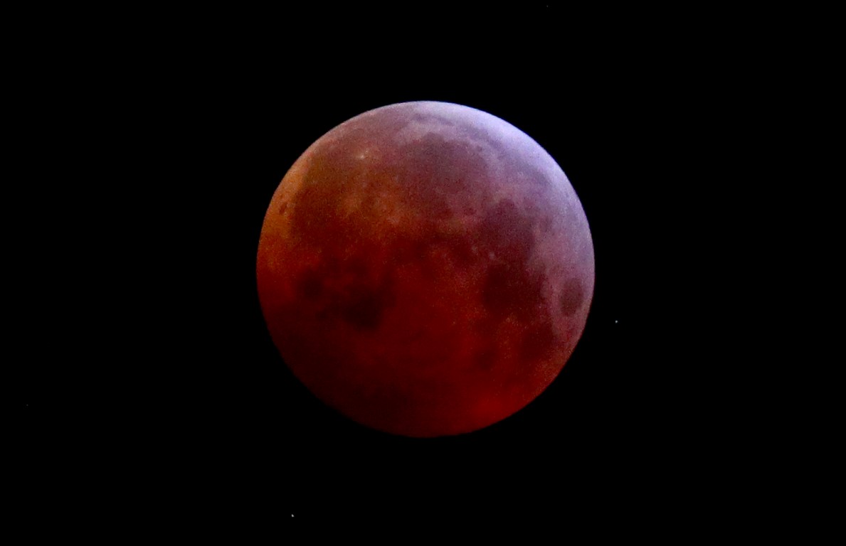 The moon is covered by the earth's shadow during a total lunar eclipse over Vienna, Austria,...